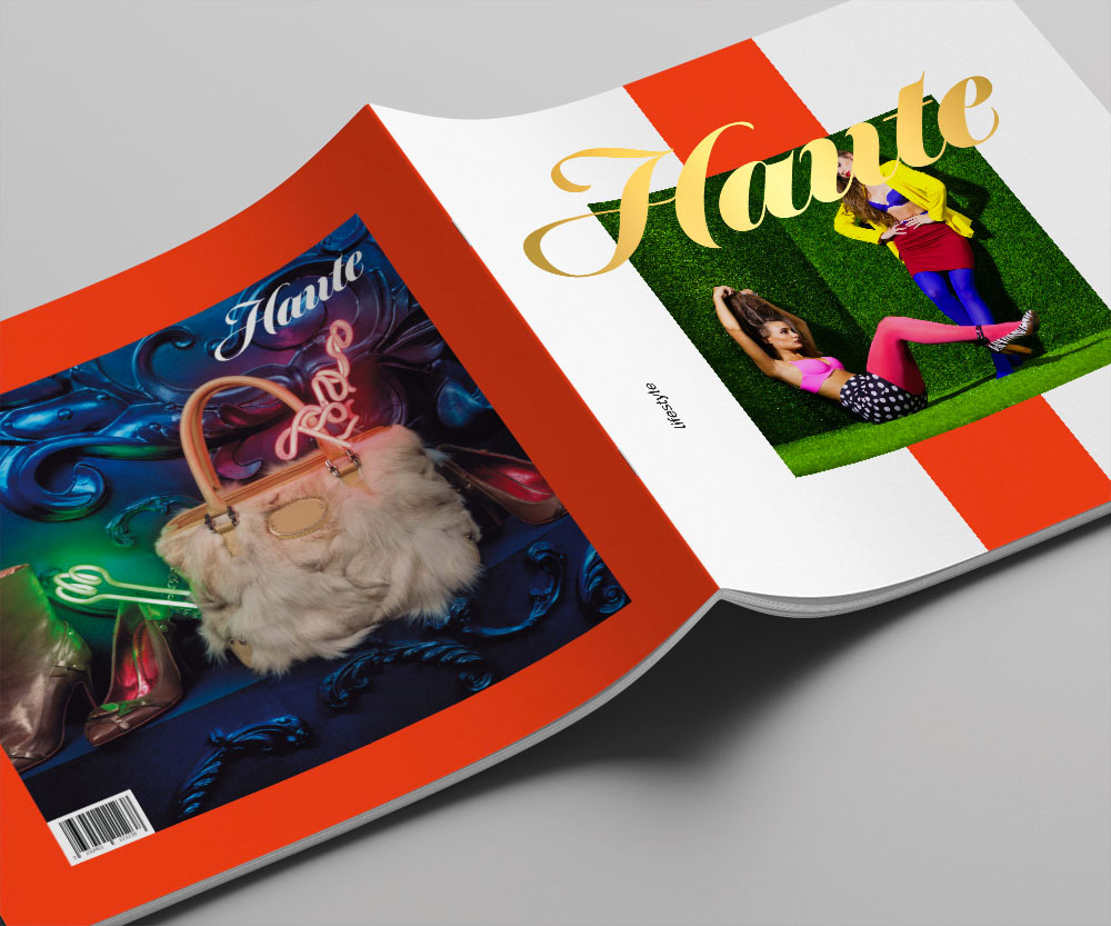 A catalog open and turned upside down for Haute fashion. On the back is a large purse on a bright colorful background. The front has two models with their handbags.