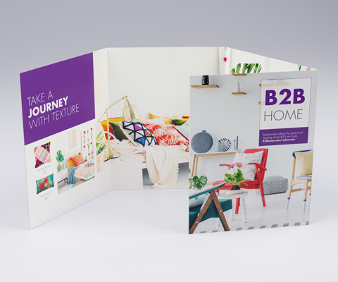 A four-panel brochure standing up on a white background. The brochure depicts a furniture store named B2B Home with brightly colored furniture images.